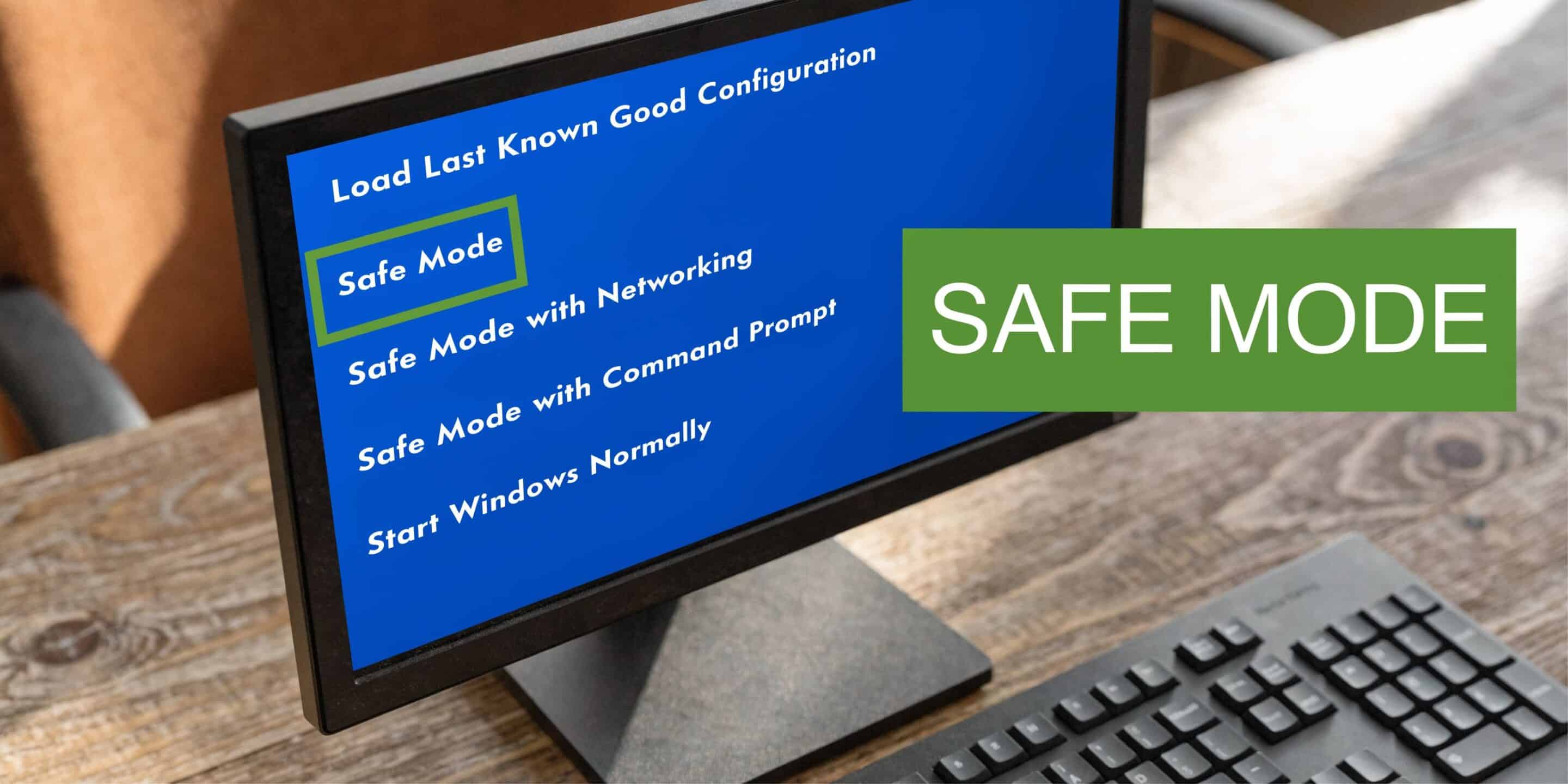 A computer monitor displaying a blue Windows startup menu with options including Safe Mode selection.