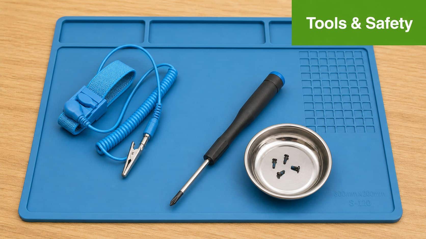 A blue silicone work mat featuring an anti-static wrist strap, a screwdriver, and a magnetic screw tray.