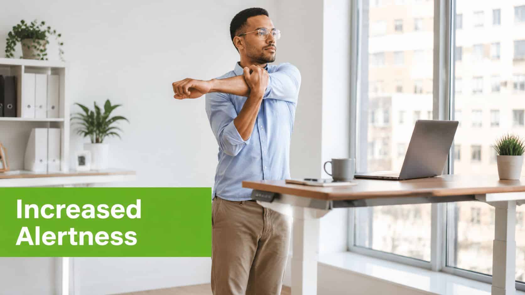 A professional man stretching while working at a modern standing desk in a bright office environment.